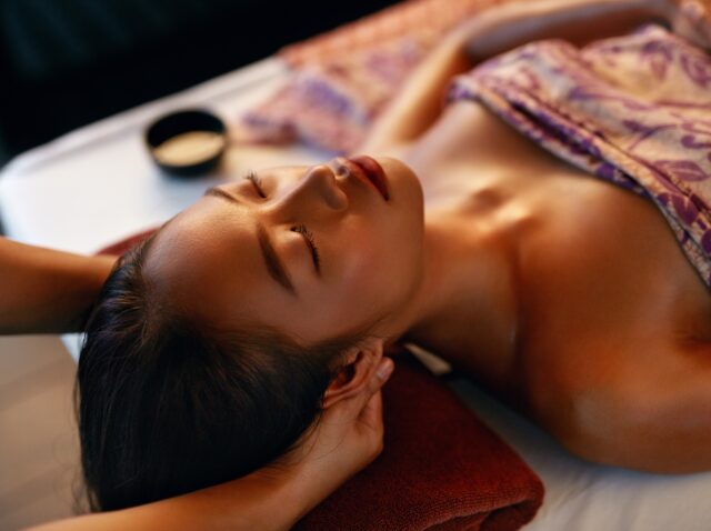Spa Massage. Hands Massaging Woman Head At Thai Beauty Salon