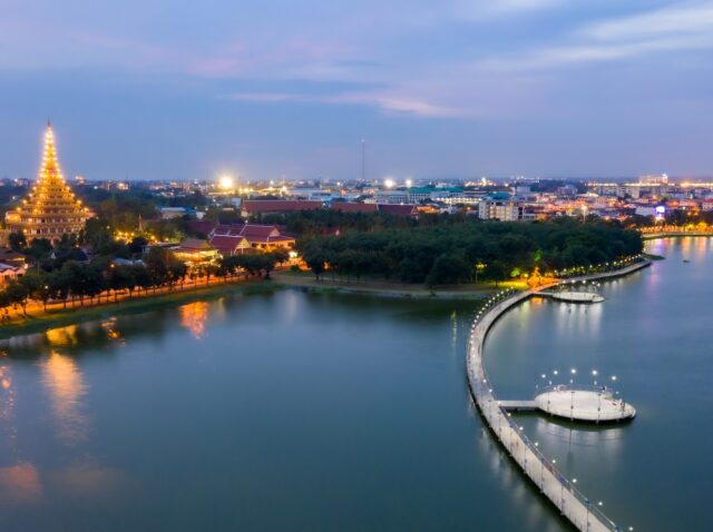 Aerial view shot of eastern Khon Kaen with Phra Mahathat Kaen Nakhon, Wat Nong Wang at twilight time in Thailand.