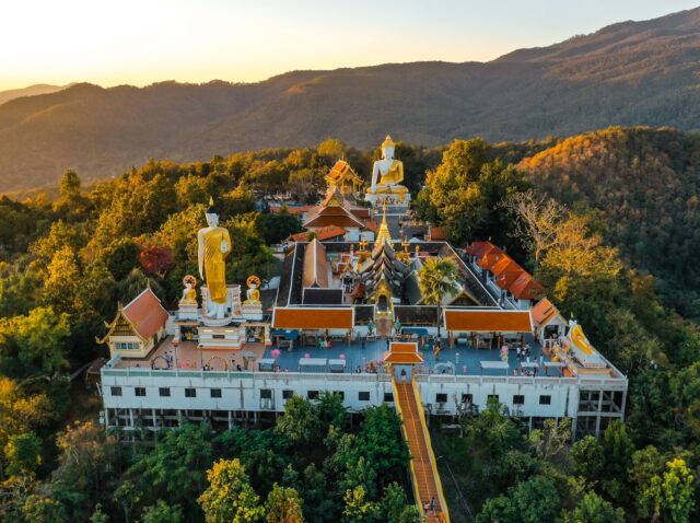 Aerial view of Wat Phrathat Doi Kham, Buddha pagoda and golden chedi in Chiang Mai, Thailand