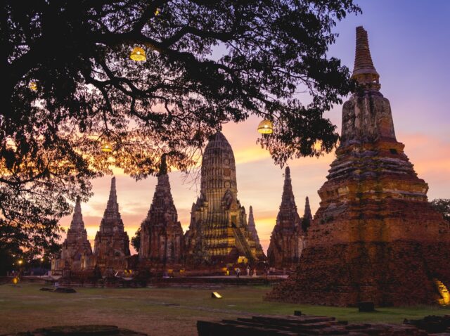 Wat Chaiwatthanaram temple at Ayutthaya in Thailand. Sunset scenery sky view in winter season. Tourism wearing traditional Thai clothing. Place of landmark popular of tourist.