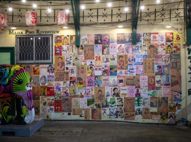 Bangkok, Thailand - January 4, 2025: Vintage posters on the wall at the entrance to Maha Pho Riverview on Song Wat Road, Bangkok, Thailand.